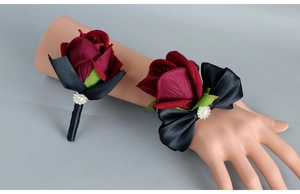 Detail of burgundy artificial rose boutonniere and wrist corsage set with pearls