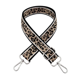 Adjustable leopard print bag strap with silver hardware on a plain white background