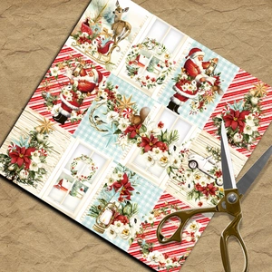 Macro shot of vintage Christmas scrapbooking papers with Santa and reindeer illustrations
