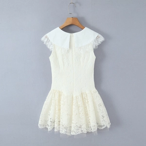 Detailed view of the elegant Peter Pan collar and delicate eyelash lace on white dress
