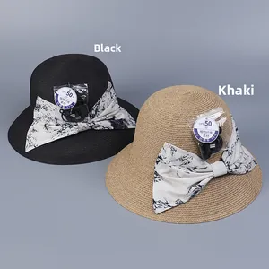 Detail of sun hats in black and khaki with floral bows and UPF 50+ woven texture