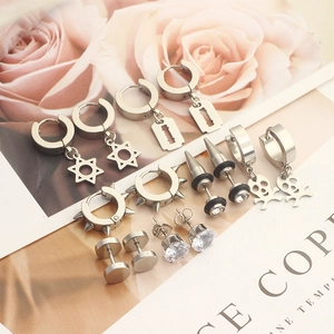 Detailed flat lay of silver stainless steel earrings set featuring star and stud designs