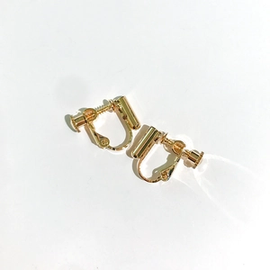 Adjustable golden screw-style earring converters for non-pierced ears on white background