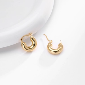Macro shot of polished S925 sterling silver gold earrings with clear hallmark engraving