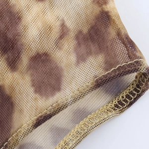 Detailed macro shot of leopard print mesh fabric with high-quality stitching and texture