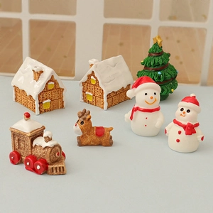 Set of 7 mini Christmas resin figurines including gingerbread house snowman and tree