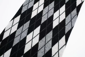 Macro shot of high-quality argyle knit fabric showing soft texture and fine fibers