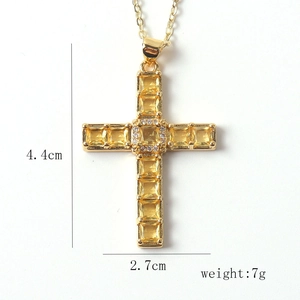 Detailed view of gold cross pendant with dimensions 4.4cm height and 2.7cm width