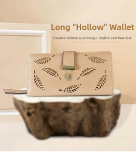 Detail view of khaki long wallet with hollow leaf design and gold leaf pendant charm