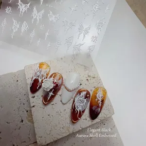 Retro 3D embossed nail stickers featuring white butterfly and cross motifs on press-on nails
