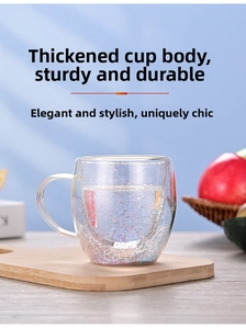 Macro view of double-walled glass cup with glitter sand and ergonomic clear handle