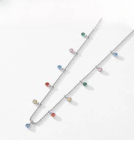 Macro detail of S925 sterling silver chain with multi-colored round zircon pendants