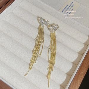 Elegant gold heart earrings with long snake chain tassels and sparkling zircon stones