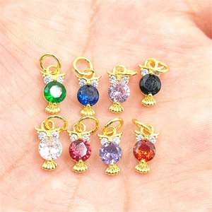 Detailed view of colorful owl cat pendants with inlaid zircon on gold plated metal frame