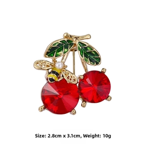 Detail of red crystal cherry brooch with bee accent and measurements 2.8cm by 3.1cm