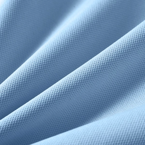 Macro detail of breathable light blue mesh fabric with soft micro-hole texture for polo shirt