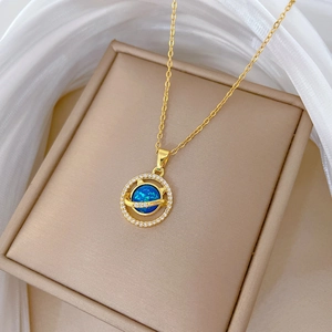 Detail of gold titanium cat planet necklace featuring blue opal and sparkling crystals