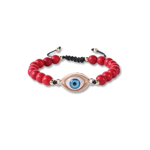 Detail of red turquoise beads evil eye charm bracelet with adjustable black braided cord
