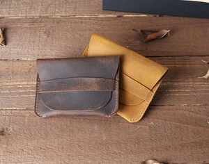 Close-up of handmade crazy horse leather wallets in dark brown and yellow colors