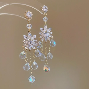 Golden flower earrings with pearl tassels and shimmering crystal teardrop pendants