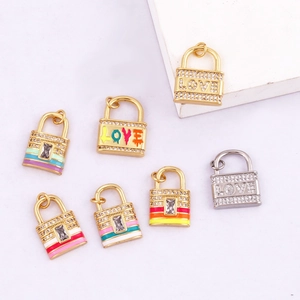 Detailed view of copper micro-pave mini lock pendants in gold and silver finishes