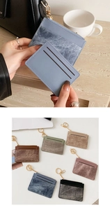Detail view of multi-slot slim leather card holder with secure gold keychain and zipper