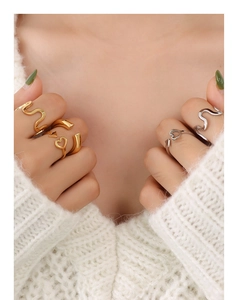 Close-up of minimalist wave and heart-shaped rings in gold and silver on a model