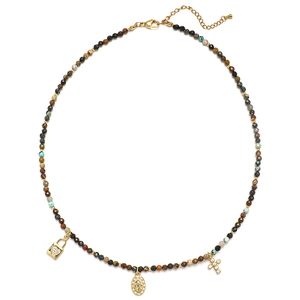 Detail of beaded necklace with gold pendants: heart lock, oval medal, and tiny cross