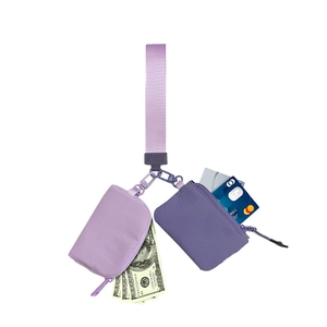 Detail view of purple multi-pouch wristlet coin purse and keychain with card and cash storage.