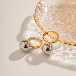 Two-tone stainless steel hoop earrings with gold rings and silver spherical pendants