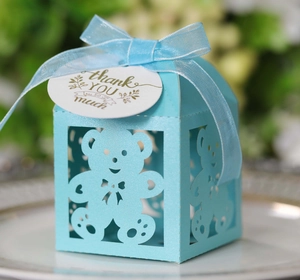 Detail of light blue baby shower favor box with bear cutout and thank you tag