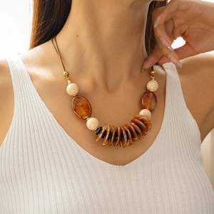 Close-up of bohemian leather necklace featuring double-layer acrylic oval pendants