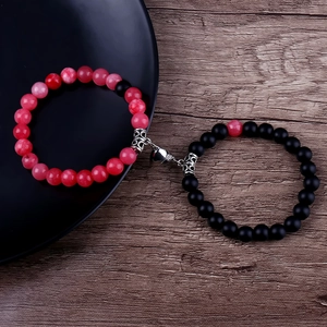 Detail of pink and black 8mm stone beads couple bracelets with silver heart magnetic clasp