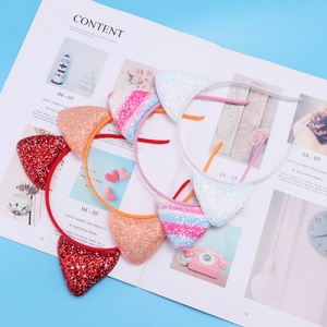 Close-up of glitter cat ear headbands in red, orange, white and blue gradient colors