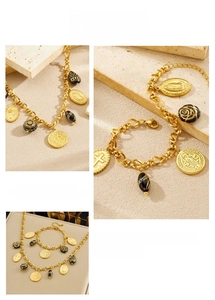 Close-up of gold chain jewelry set featuring black rose and religious relief pendants