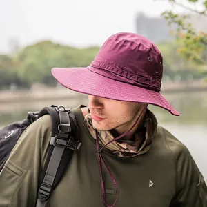 Outdoor wide-brim sun hat in magenta with mesh vents and windproof strap for hiking