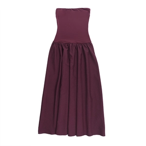 Detail of burgundy tube top dress with high waist pleated hem on white background