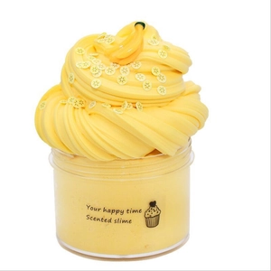 Close-up of yellow scented butter slime kit with lemon slice and banana charms