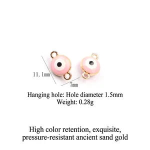 Detail of pink evil eye charms with gold metal frames for DIY jewelry making