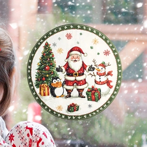 Detail view of festive round Santa and snowman static window sticker on glass surface