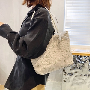 Straw woven tote bag with floral embroidery and white lace bow for casual summer style