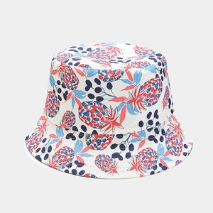 Detail of white canvas bucket hat with red and blue pineapple print and reinforced brim