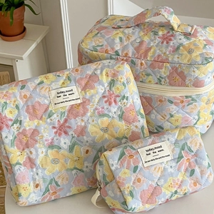 Quilted floral makeup bag set including vanity case, zipper pouch, and pencil case
