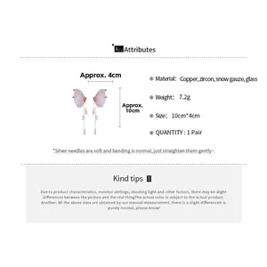 Detailed view of butterfly tassel earrings with pink chiffon wings and zircon accents