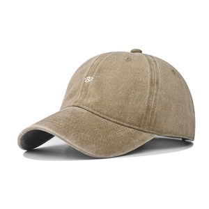 Detailed close-up of white R letter embroidery on a khaki vintage washed baseball cap