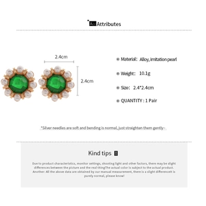 Detail view of flower earrings with green gem and pearls including size and weight specs