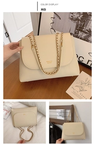 Detail of off-white faux leather handbag with lychee texture and gold chain strap