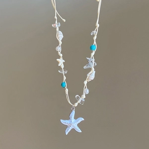 70cm braided necklace featuring white starfish pendant and natural seashell accents
