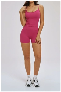 Front view of hot pink two-piece sports set featuring a strappy tank top and high-waisted shorts