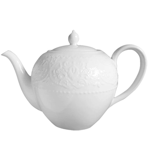 White ceramic teapot with elegant relief patterns and curved spout for afternoon tea